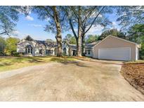 Charming single-story home with a large driveway and well-maintained lawn at 2490 Turtle Ter, Grayson, GA 30017