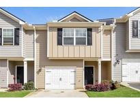 Charming townhome featuring a one-car garage, well-maintained landscaping, and neutral siding at 507 Highwood Ln, Atlanta, GA 30344
