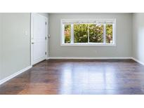 Bright living room featuring hardwood floors, a large window, and neutral paint, creating a welcoming atmosphere at 101 Ardmore Nw Pl # 3, Atlanta, GA 30309