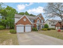 Charming brick home with a two-car garage and well-manicured lawn in a suburban setting at 5155 Amberden Hall Dr, Suwanee, GA 30024