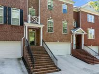 Brick townhomes with inviting entrances and attached garages at 144 Wetherbrooke Ln # 4, Smyrna, GA 30082