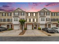 Charming townhouse exterior with attached garages and well-maintained landscaping at 2513 Ivey Crest Cir, Tucker, GA 30084