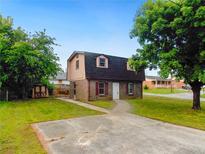 Charming home with a brick facade, shingled roof, small lawn, and separate storage shed at 10 Hawk Nw Rd, Cartersville, GA 30121
