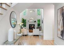 Open-concept living room showcasing a fireplace and abundant natural light from large windows at 790 Thornberry Dr, Alpharetta, GA 30022