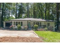 Charming, one-story home with a well-manicured lawn, carport, and inviting front porch at 1992 Cascade Sw Rd, Atlanta, GA 30311