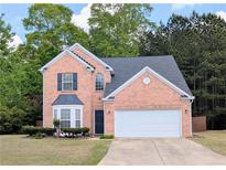 Charming brick home with a well-manicured lawn and two-car garage at 2203 Beacon Crest Dr, Buford, GA 30519