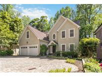 Elegant home featuring a circular driveway, two-car garage, and lush landscaping at 2651 Briarlake Rd, Atlanta, GA 30345