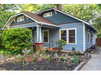 Charming blue home with a well-manicured front yard and inviting covered porch area at 959 Berne Se St, Atlanta, GA 30316