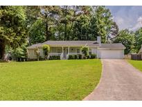 Charming single-story home features a well-maintained lawn and inviting curb appeal at 228 Amour Sw Way, Lilburn, GA 30047