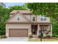 Charming two-story home featuring a covered front porch and well-maintained landscaping at 4876 Briarcliff Dr, Sugar Hill, GA 30518