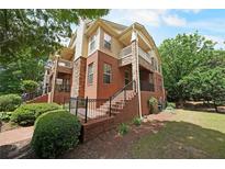 Charming townhome featuring brick and stone facade with private balconies and well-maintained landscaping at 718 Province Se Pl, Atlanta, GA 30312