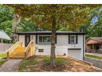 Charming white-brick home with newly built stairs and a well-maintained front yard at 208 Silver Springs Sw Cir, Atlanta, GA 30310