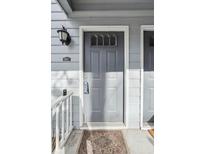 Charming gray front door with transom window and stylish welcome mat at 3980 Riverlook Se Pkwy # 203, Marietta, GA 30067