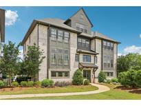 Beautiful brick condo building with manicured lawn and walkway to entrance on a sunny day at 215 Britten Pass, Alpharetta, GA 30009