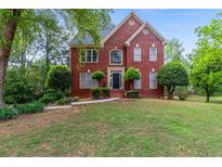 Charming two-story brick home with manicured landscaping and a well-maintained lawn at 1720 Greystone Trce, Conyers, GA 30013