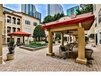 Beautiful courtyard with brick pavers, covered seating, and lush landscaping offers a tranquil retreat at 955 Juniper Ne St # 2322, Atlanta, GA 30309
