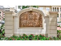 Close-up of the Tuscany Condominiums sign with floral landscaping below at 955 Juniper Ne St # 2322, Atlanta, GA 30309