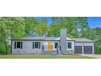Charming ranch-style home features a freshly painted exterior and updated landscaping with a bright yellow front door at 4336 Southvale Dr, Decatur, GA 30034