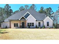 Charming single-story home with beautiful brick facade, inviting front porch, and well-maintained lawn at 261 Arborview Dr, Mcdonough, GA 30252