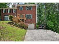 Charming two-story brick home with a front porch, attached garage, and landscaped front yard at 187 Timber Creek Sw Ln, Marietta, GA 30060