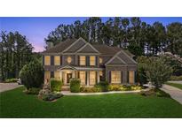 Beautiful brick home featuring manicured landscaping, a covered porch, and a classic architectural design at 249 Thorncliff Lndg, Acworth, GA 30101
