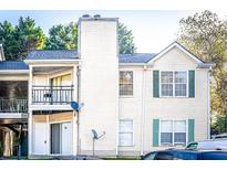 Multi-Gathering condo property featuring a balcony, neutral siding, and well maintained outdoor grounds at 414 Ridge Creek Dr, Clarkston, GA 30021