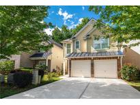 Charming two-story home with a two-car garage and well-maintained landscaping at 2034 Reavis Blf, Conyers, GA 30012