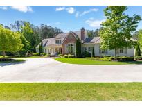 Stunning two-story home with a well-manicured lawn and a circular driveway, perfect for luxurious living at 101 Morgan Ln, Canton, GA 30115
