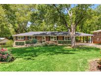 Charming brick ranch home with mature landscaping and a covered carport at 1901 Trophy Dr, Marietta, GA 30062