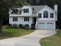 Charming two-story home with a well-manicured lawn, attached two-car garage, and inviting curb appeal at 22 Briar Chase Ct, White, GA 30184