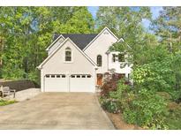 Charming home featuring a two-car garage and beautiful landscaping at 601 Ashley Forest Nw Dr, Acworth, GA 30102
