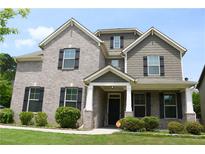 Charming two-story home featuring a well-manicured lawn and an inviting front entrance at 1143 Park Hollow Ne Ln, Lawrenceville, GA 30043