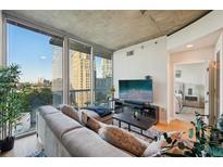 Bright living room with large windows offering city views and comfortable seating area at 3324 Peachtree Ne Rd # 1104, Atlanta, GA 30326