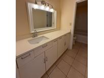 Bright bathroom features a white vanity with ample storage and a large mirror at 3575 Oakvale Road # 303, Decatur, GA 30034