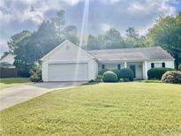 Charming one-story home with a well-manicured lawn and a two-car garage at 431 Crested View Dr, Loganville, GA 30052
