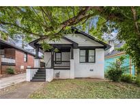 Charming bungalow with a brick foundation, covered porch, and well-manicured lawn at 554 Lawton Sw St, Atlanta, GA 30310