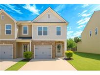 Charming townhouse with a brick facade, one-car garage, well-manicured lawn, and beautiful curb appeal at 4925 Longview Walk, Decatur, GA 30035