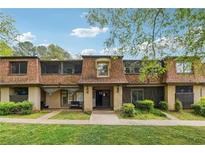 Charming townhouse featuring a unique mansard roof design and beautiful lawn at 2930 Parc Lorraine, Lithonia, GA 30038