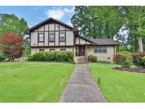 Charming home with a well-manicured lawn, lush landscaping, and inviting walkway at 2272 Plantation Ct, Lawrenceville, GA 30044