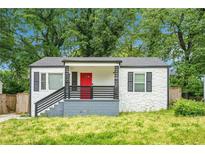 Charming bungalow with stone exterior, red front door, and a well-maintained front yard at 248 Upshaw Sw St, Atlanta, GA 30315