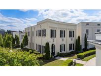 Elegant two-story building featuring a painted brick facade, manicured landscaping, and black shutters at 316 S Esplanade, Alpharetta, GA 30009
