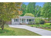 Charming single-story home with a well-manicured lawn and a long driveway at 2205 Desmond Dr, Decatur, GA 30033