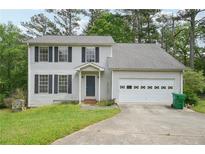 Charming two-story home featuring a classic colonial design and an attached two-car garage at 7117 Stonebrook Cv, Lithonia, GA 30058