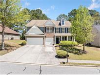 Charming two-story home with a well-manicured lawn and a spacious driveway, inviting curb appeal at 1657 Preserve Park Dr, Loganville, GA 30052