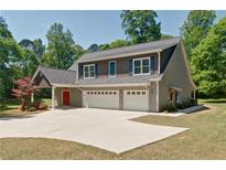 Beautiful two-story home with three-car garage, carriage and gray siding and blue shutters at 5800 Villa Rica Hwy, Dallas, GA 30157