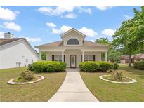 Charming single-story home featuring a covered front porch and manicured landscaping at 310 Autumn Glen Cir, Fayetteville, GA 30215