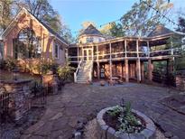 Expansive backyard with stone patio and lovely brick home featuring a gazebo-style screened-in porch at 3978 Devonshire Dr, Marietta, GA 30066