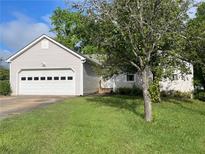 Charming single-Gathering home with two-car garage, lush lawn and tree-lined front yard at 53 Villa Rosa Way, Temple, GA 30179