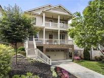 Charming two-story home featuring a stone foundation, double porches, and beautifully landscaped front yard at 1165 Victoria Ne St, Brookhaven, GA 30319
