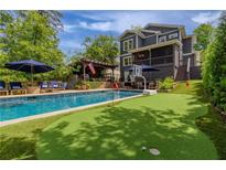 Stunning backyard with a pool, putting green, and outdoor seating area perfect for entertaining at 2406 Glenwood Ne Dr, Atlanta, GA 30305